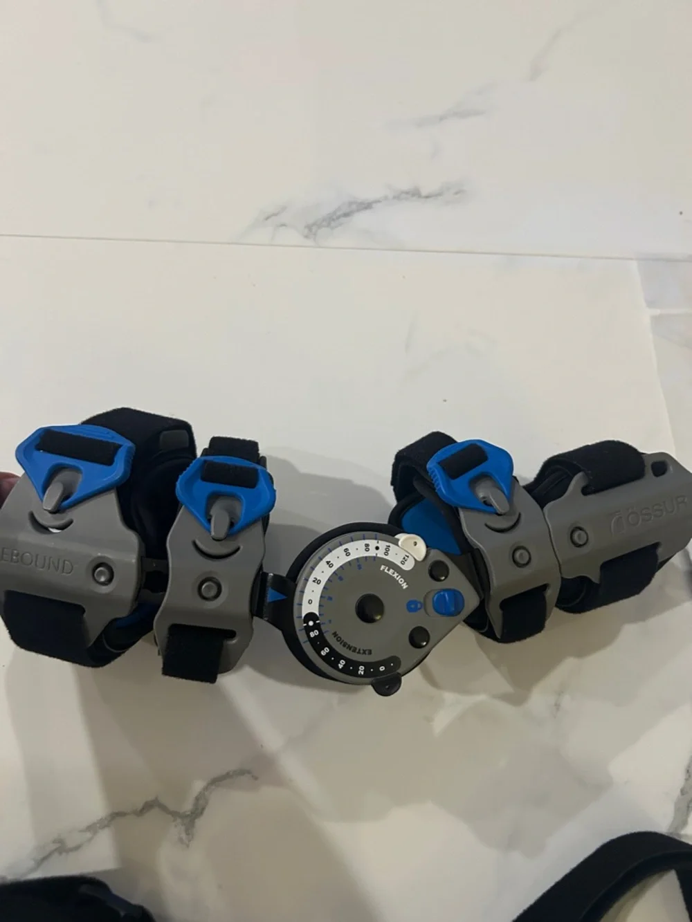 Össur Rebound Post-Op Elbow Brace Adjustable Black Gray Blue, right hand.
